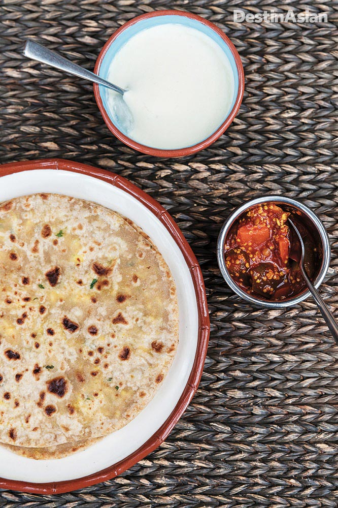 Paneer paratha with yogurt and chutney.