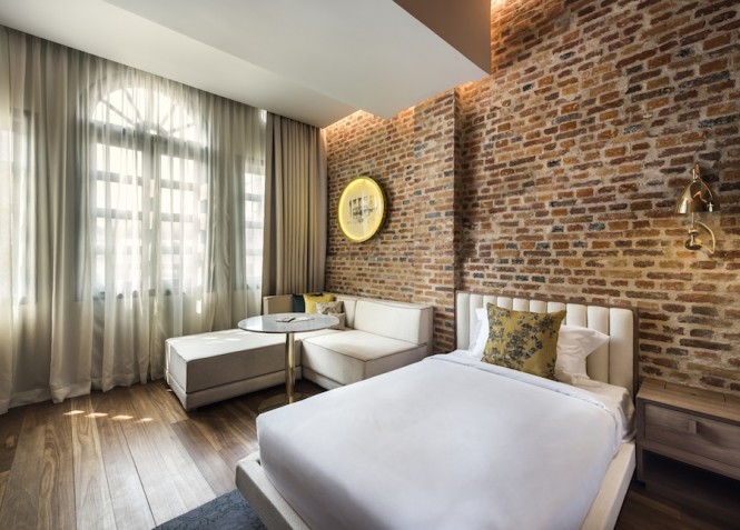 The shophouses' orignal brick walls and wood floors are complimented with local artwork and colorful throw pillows.
