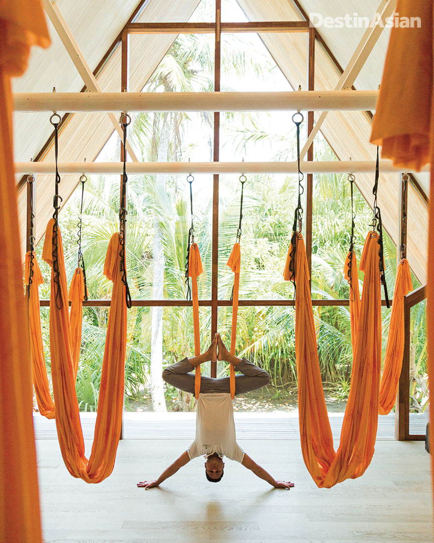 The St. REgis Maldives Commuli's in-house yoga master Muhammed Faisal demonstrating anti-gravity yoga. 