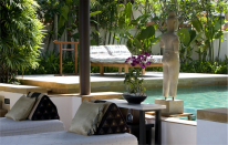 Massage beds and sun loungers by the pool.