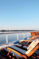 Steamer chairs line the top deck of the Road to Mandalay.