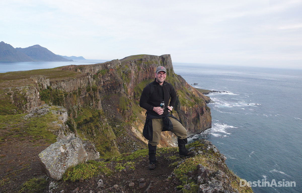 Hiking guide Siggi Olafsson high above the Atlantic surf on the Barðsnes Peninsula.