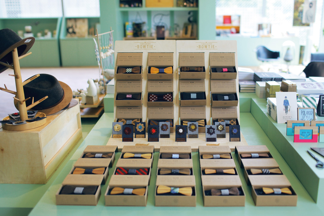 Handmade wooden bow ties on display at K+ Curatorial Space.