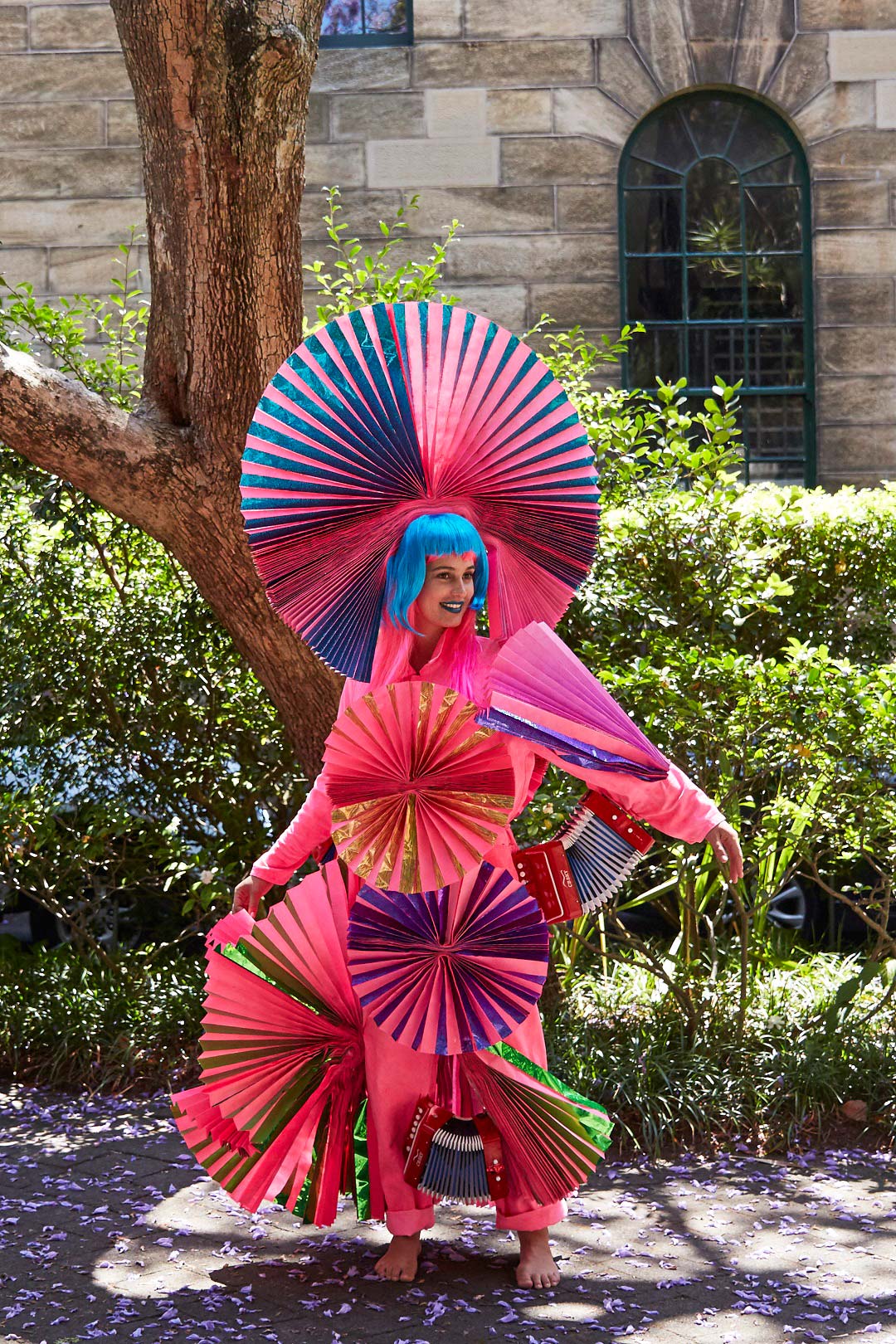 A performer in costume for the concertina dance Two Fold by Justene Williams.
