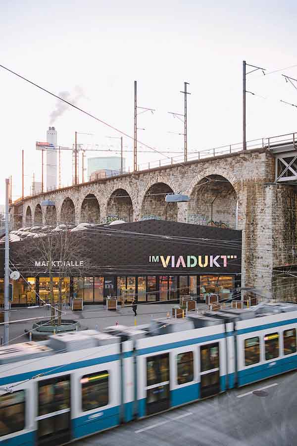 Im Viadukt, a market hall built around the stone arches of a 19th-century railway bridge.