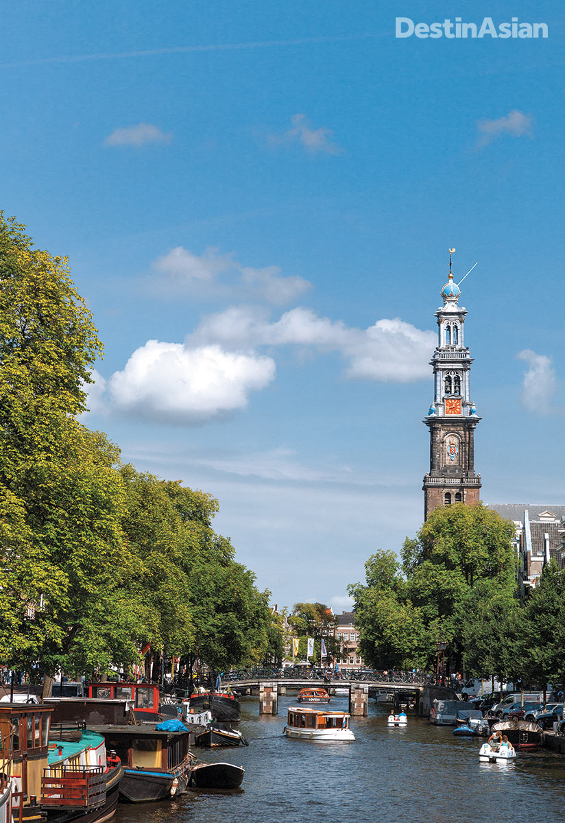 Looking north along the grand Prinsengracht canal toward the tower of the Westerkerk.