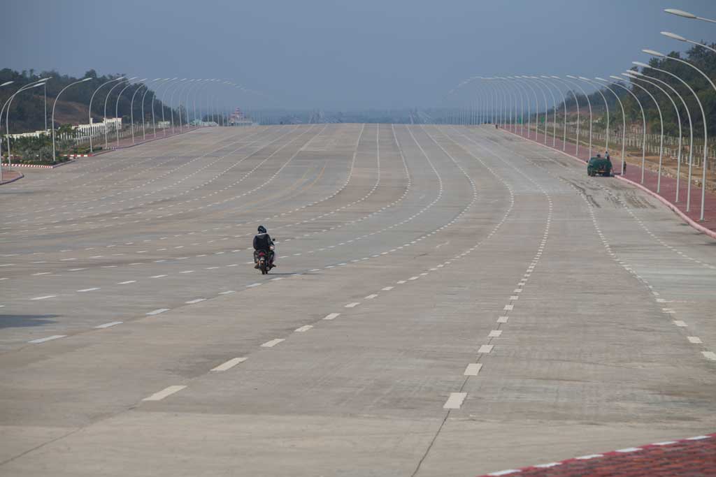 A sole motorbike travels along the 20-lane road that leads to the country's parliament complex in Naypyidaw.