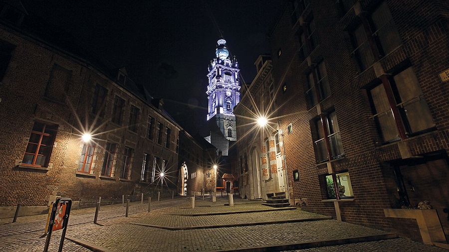 The Belfry in Mons, built in the 17th century, alight at night.