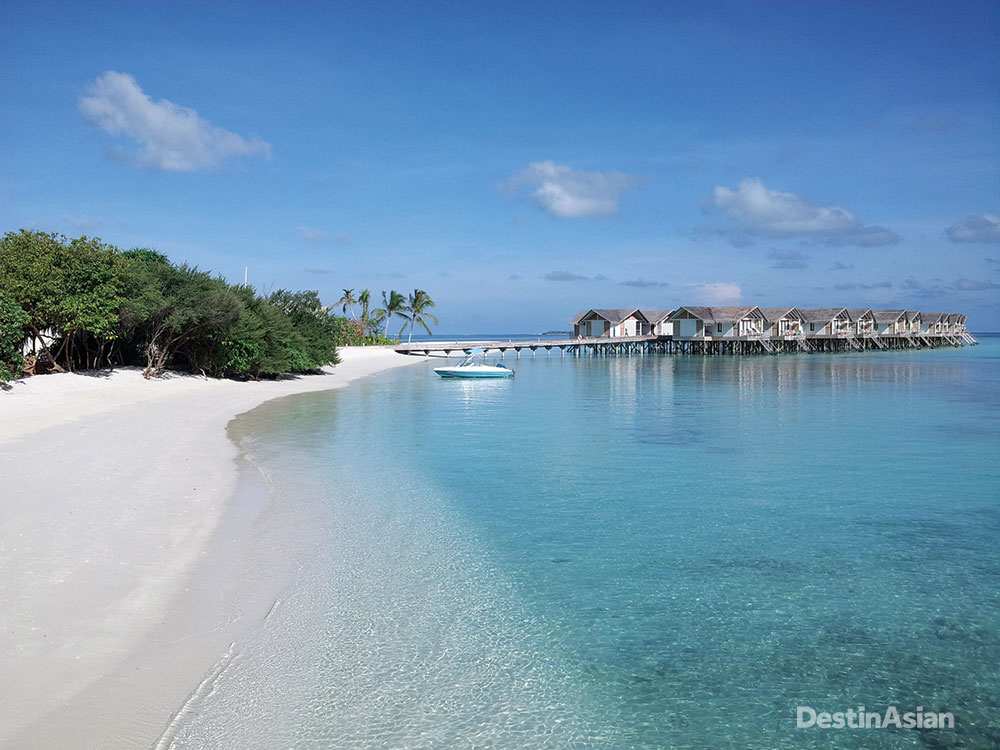 The resort's 55 overwater villas and suites are connected by a jetty to the northern end of the island, with golf buggies on hand to shuttle guests to and fro.