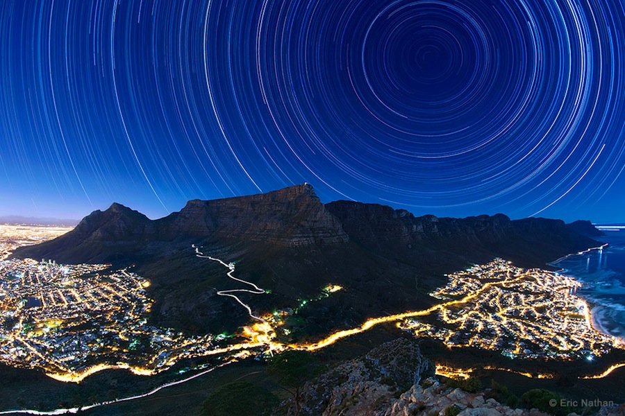 'Star Trails Above Table Mountain' by Eric Nathan (www.ericnathan.com). The image juxtaposes a moonlit Table Mountain and the star trails above it with the artificial lights of Cape Town, South Africa, created from a stack of over 90 30-second exposures, captured in June 2014. The first winner in the Against the Lights category.