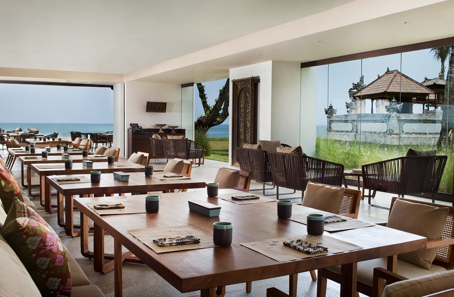 Tables in the restaurant offer calming views of the property's Balinese temple and the ocean beyond.