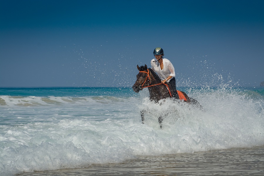 Carol Sharpe on a beach ride, one of the resort's most popular equestrian activities.