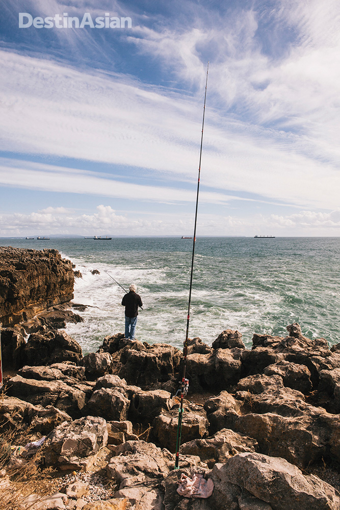 Fishing from a cliff in Cascais.