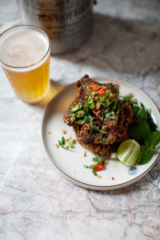 Chom Chom's addictive VFC (Vietnamese fried chicken) go well with a glass of Saigon beer.