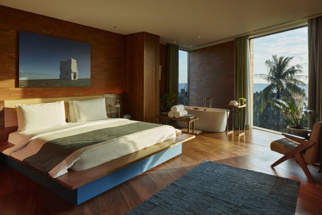 Inside the bedroom of the singular Katamama Suite at Potato Head Suites.