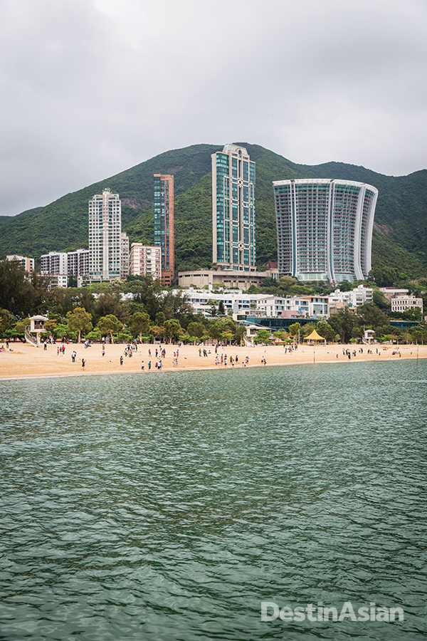 Luxury apartments rise behind the beach of southern Hong Kong's Repulse Bay.
