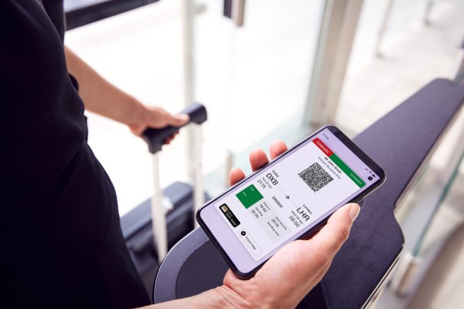 An Emirates mobile boarding pass displayed on a smartphone.