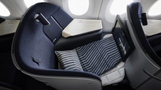 A Finnair AirLounge business-class seat in sleeping position.