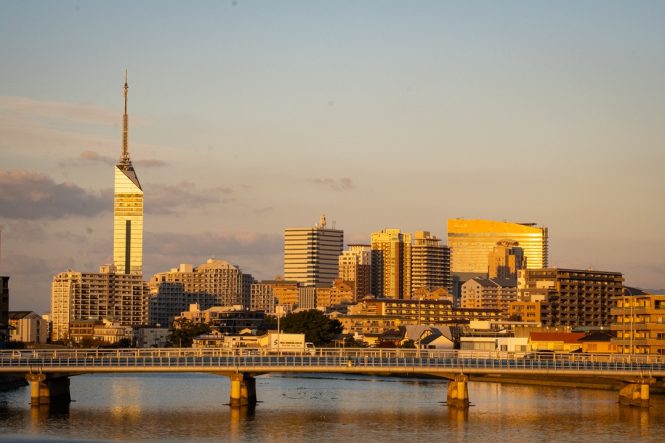 The Fukuoka skyline rising above the Muromi River.
