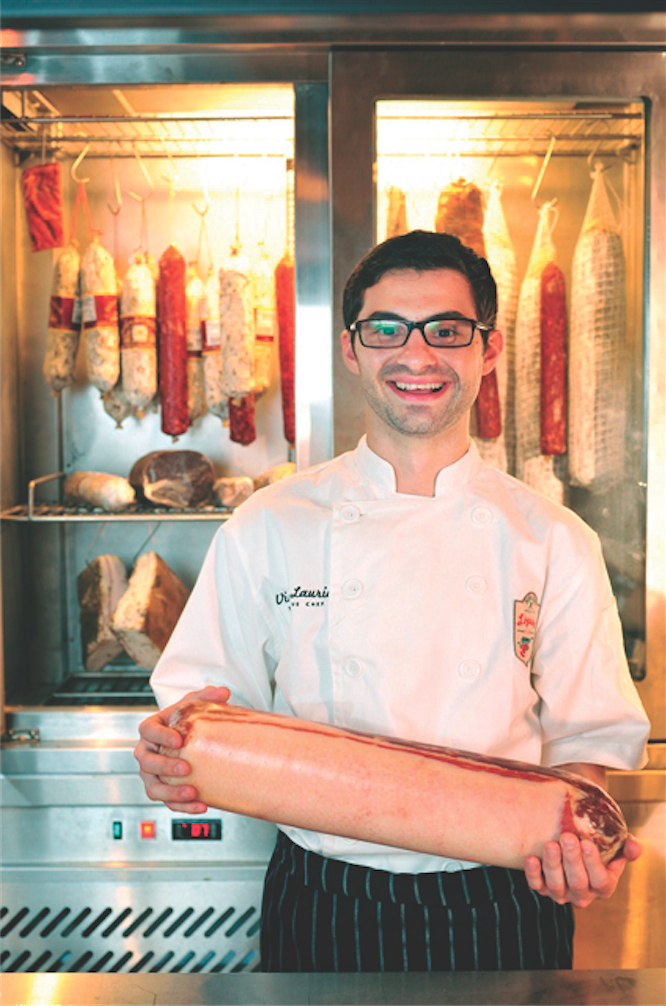Chef Vinny Lauria shows off a roll of pancetta.