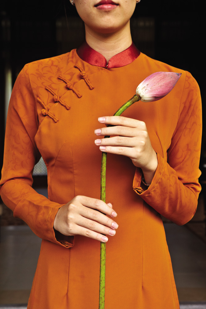 A receptionist at Banyan Tree Lang Co proffering a lotus, Vietnam’s national flower.