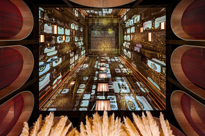 On weeknights, digital projections light up the void over Japanese restaurant Wa-Ra.