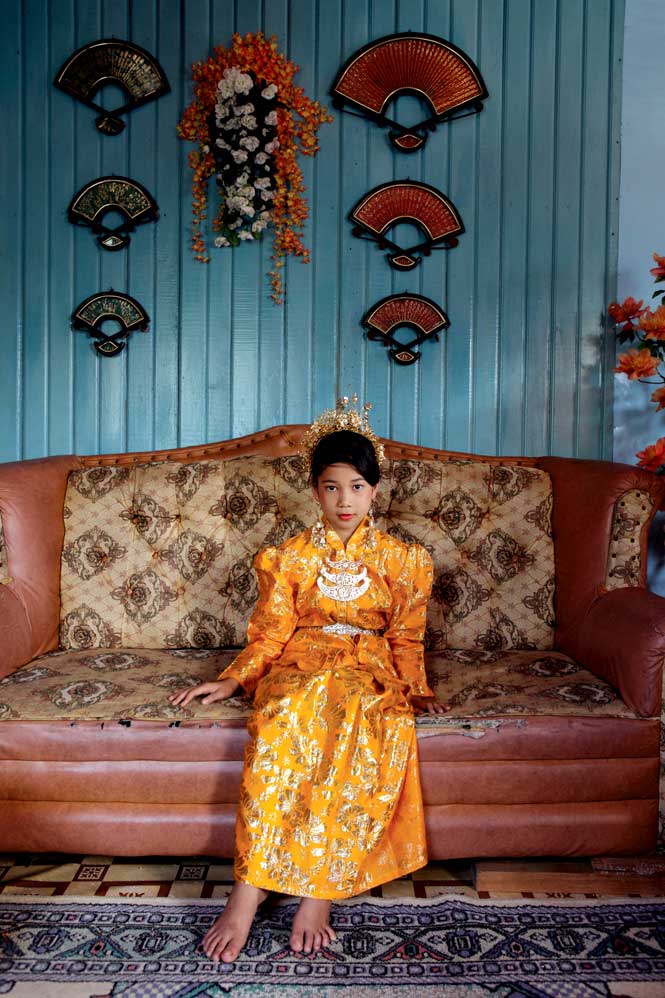 A young dancer taking a break between performances at Tanjung Sembik village, in the Natuna Islands.