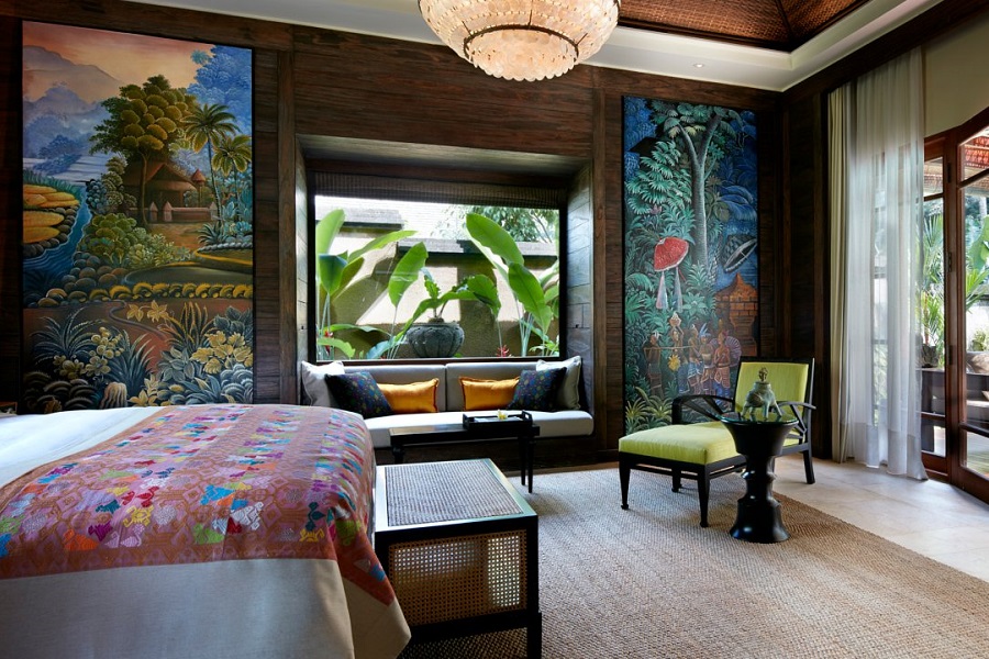 The one bedroom pool villa at Mandapa, adorned with paintings on the wall and colorful accents.