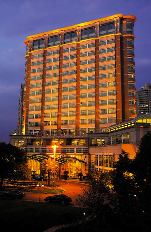 The exterior of the Radisson Blu Plaza Xing Guo at night.
