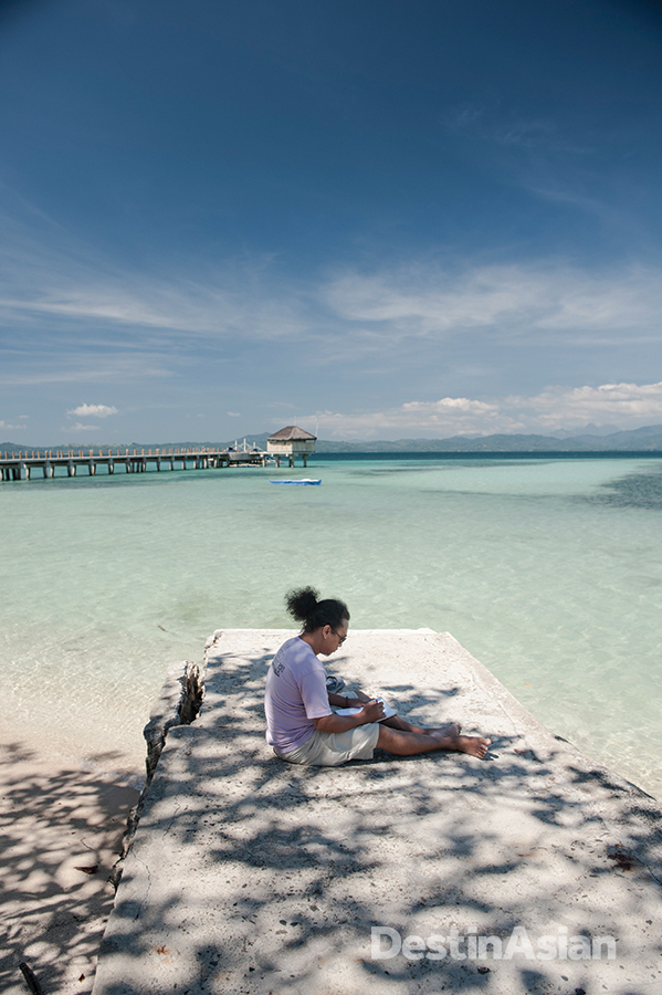 Jonathan Benitez working on a sketch of Honda Bay at Dos Palmas Island Resort, where he is artist-in-residence.
