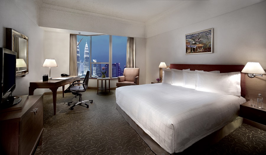 A deluxe room at Pullman KLCC, with a view of the Petronas Tower. 
