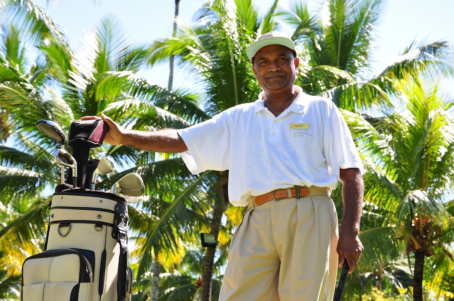 Ramesh pauses with his clubs on the course.