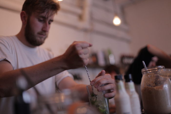 A bartender mixes drinks at hipster-hangout Seven.
