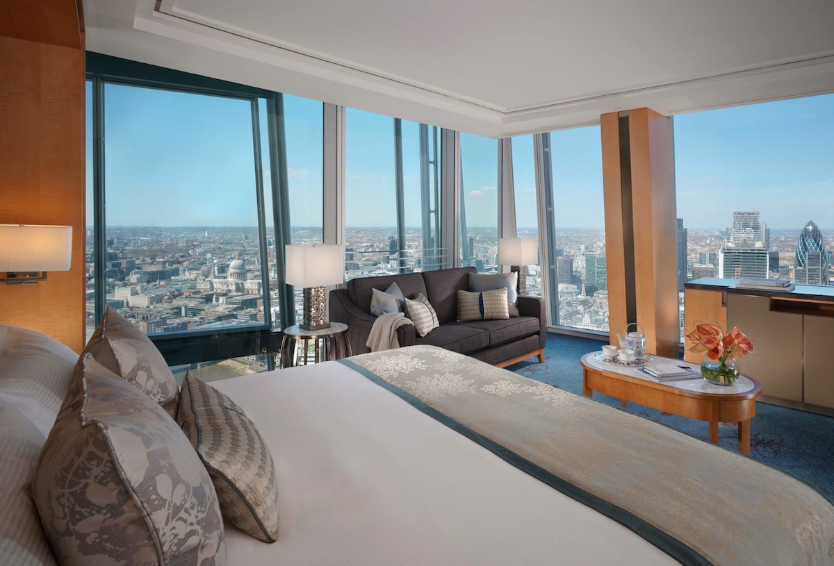 Floor-to-ceiling windows offer views of the River Thames.