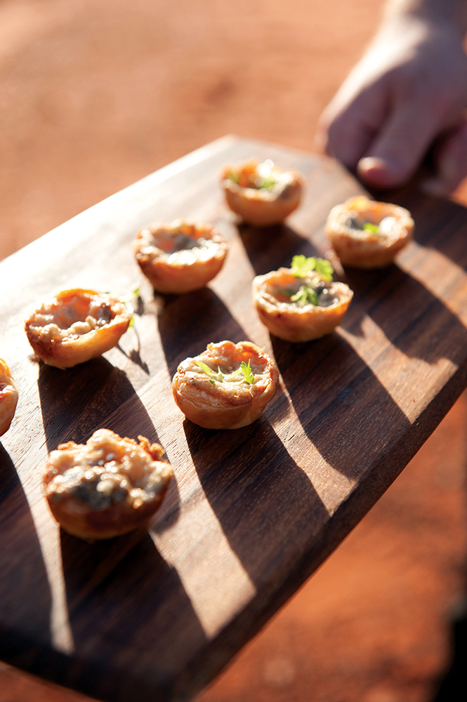Sunset canapes and champagne kick off the Tali Wiru experience.