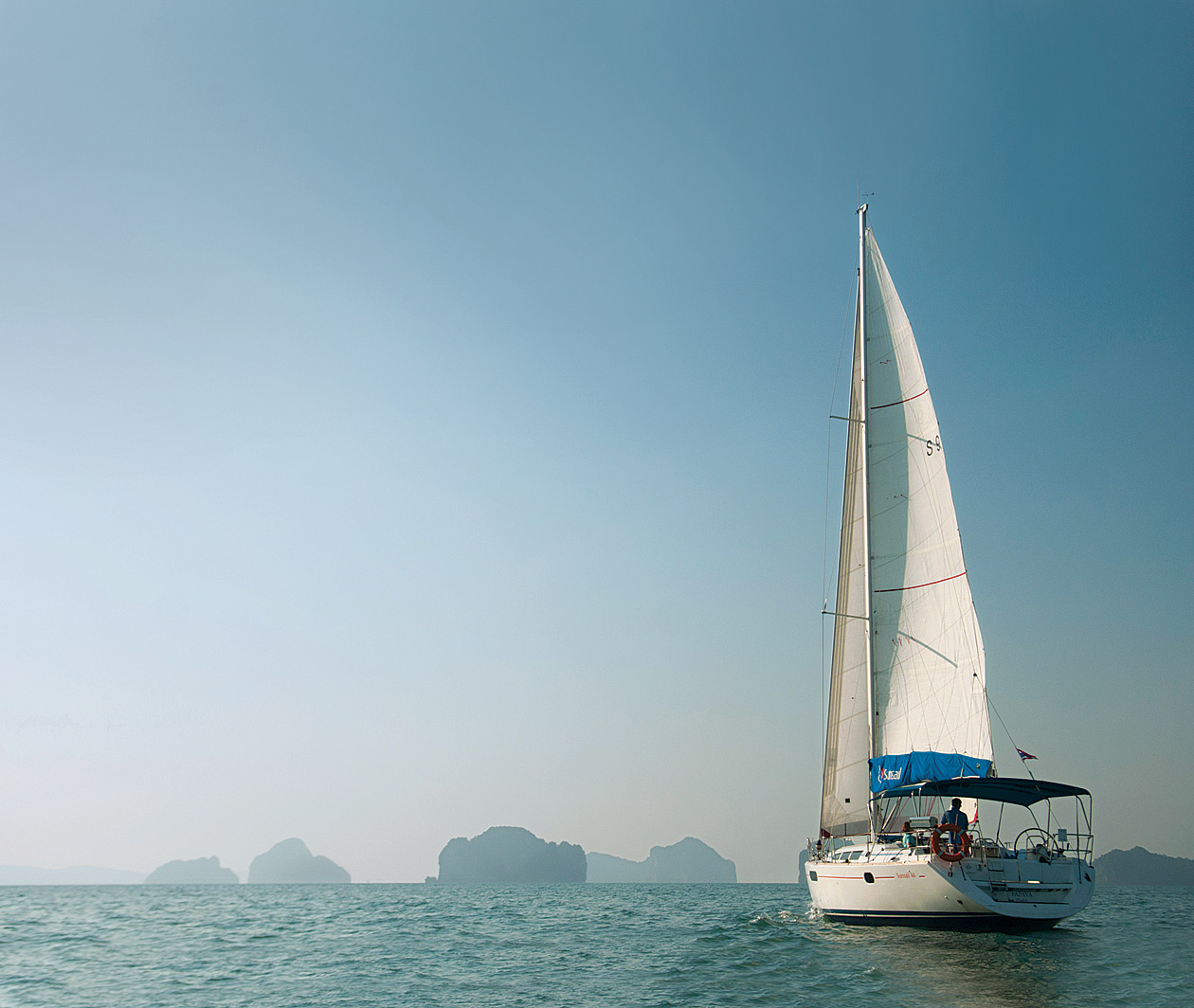 The sloop Papaya sailing into the karst-studded seascape of Phang Nga Bay, most of which is protected as a national marine park.