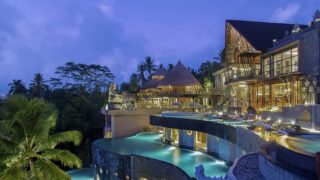 The Kayon Jungle Resort and its three-tiered infinity pools at twilight.