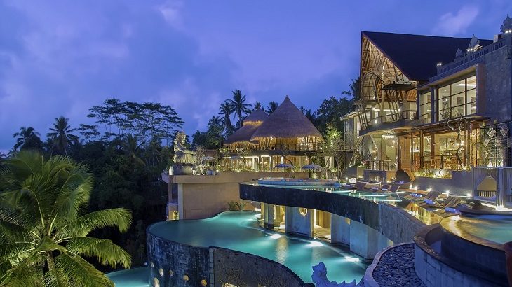 The Kayon Jungle Resort and its three-tiered infinity pools at twilight.