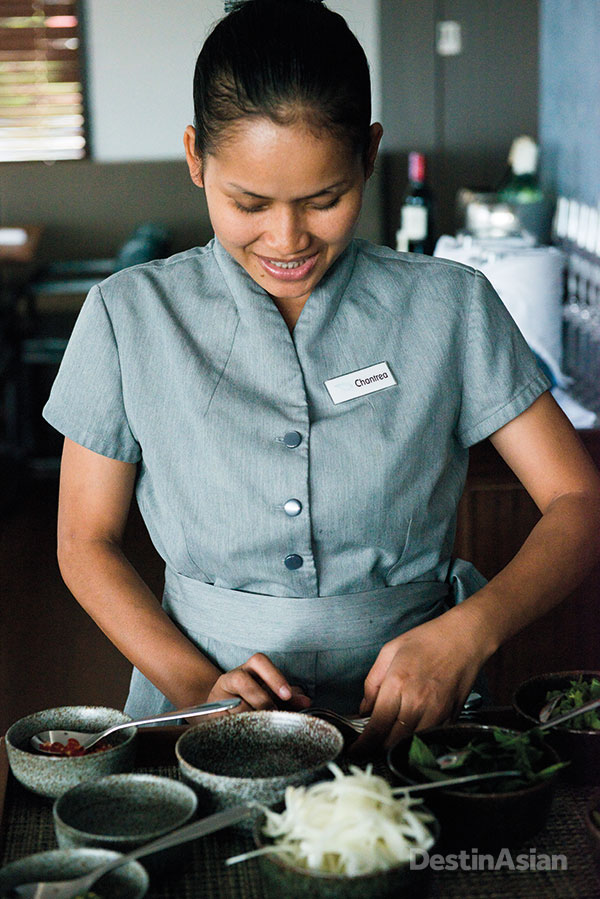 One of the boat's Cambodian restaurant staff preparing condiments.