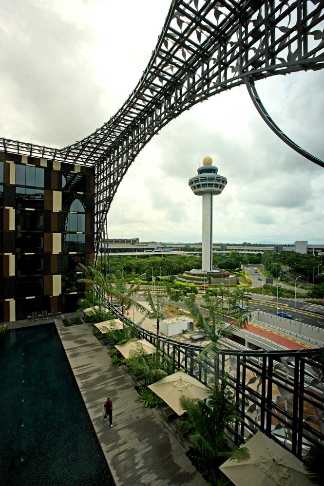 The hotel’s latticework facade frames a view of Terminal 3’s control tower.