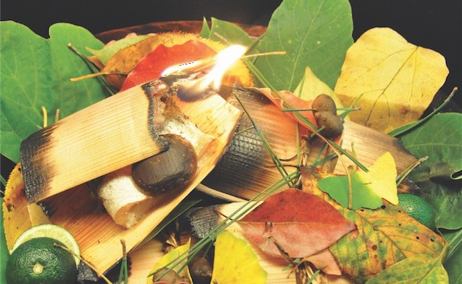 Kyoto cuisine: The Kamasu no Sugiita Yaki at Kikunoi presents grilled barracuda on a plate with autumn leaves and a piece of burning cedar.