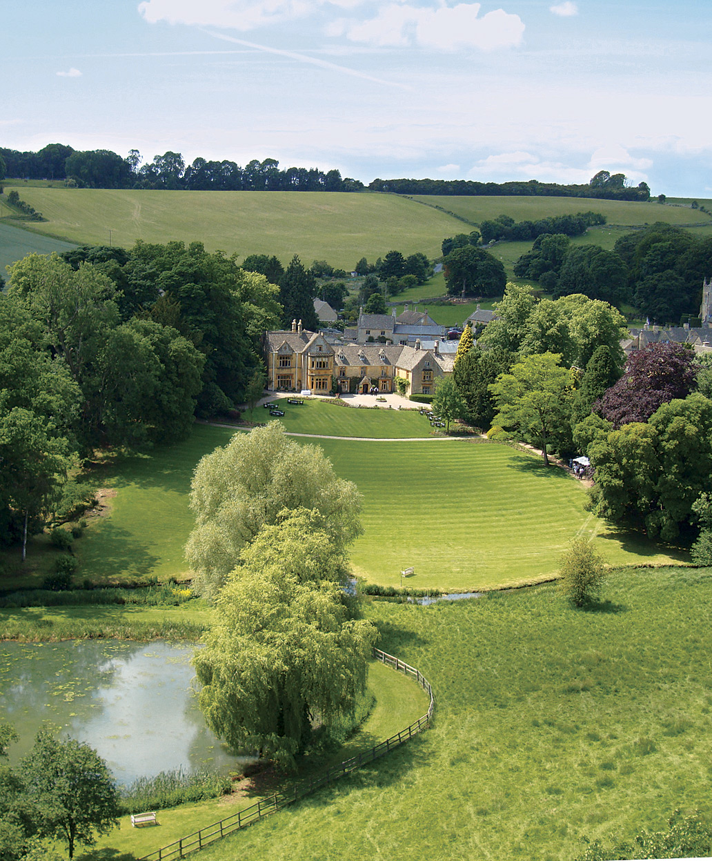 Lords of the Manor Hotel is a former 17th-century rectory built of honey-colored Cotswold stone and set amid three hectares of walled garden and parkland outside of the village of Upper Slaughter.